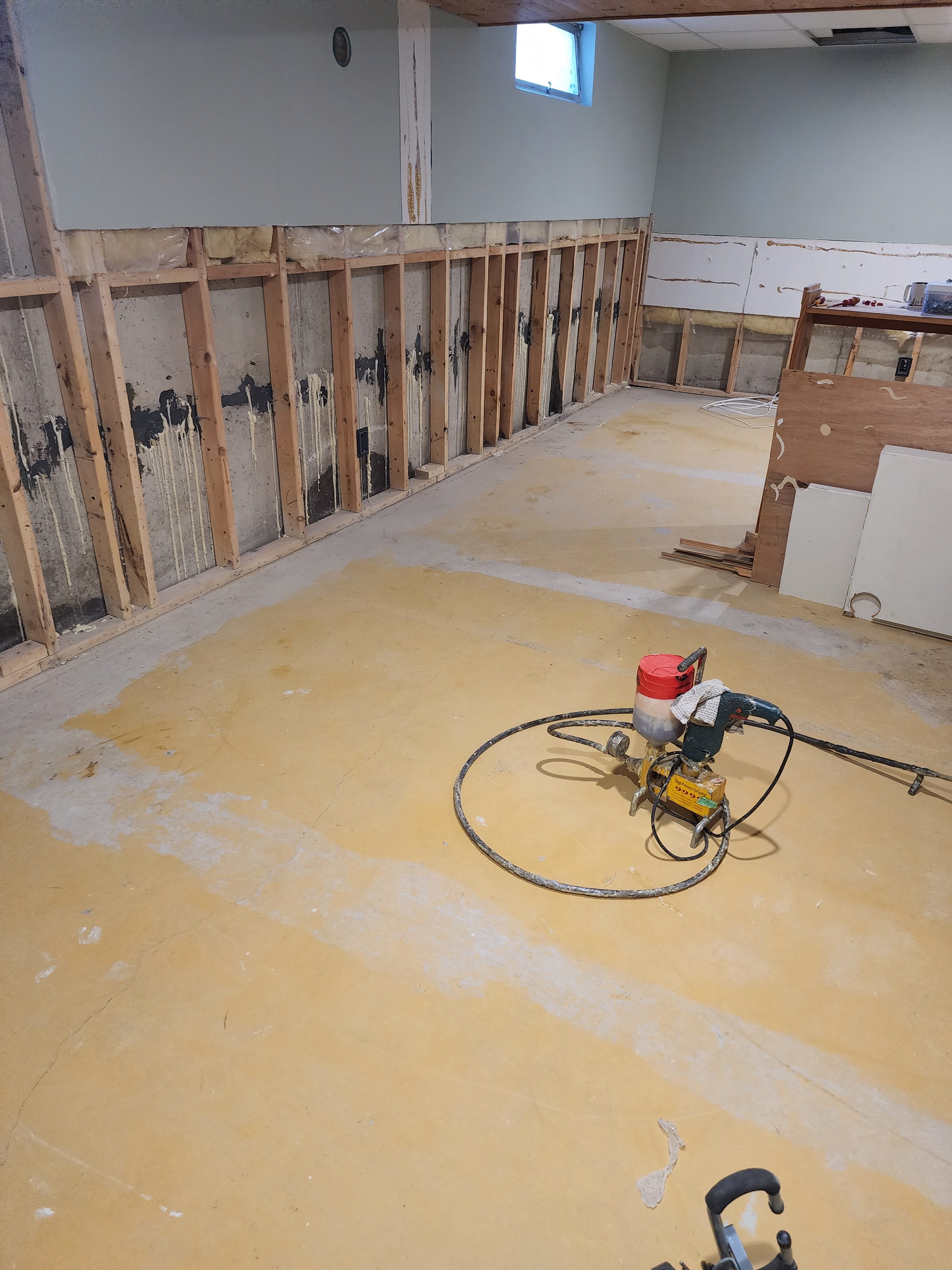 Basement Wall With Exposed Wooden Studs And Concrete Foundation Showing Signs Of Water Damage, With Foundation Repair